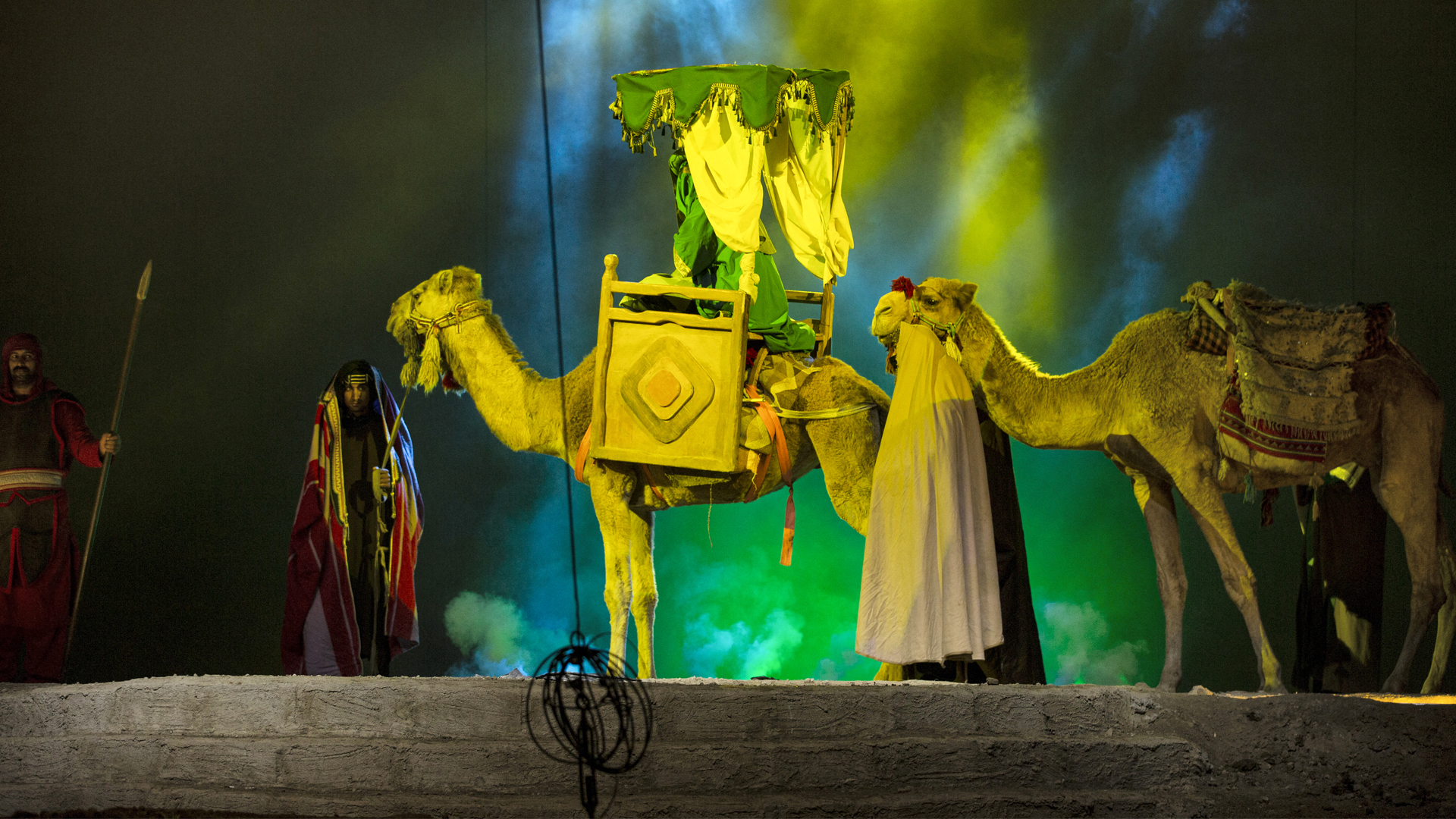 Actors dressed up as members of the Prophet Mohamed's household enact a scene from a play titled 